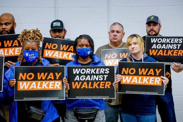 Workers in Georgia protest speak against Herschel Walker during a press conference in Atlanta