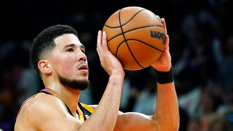 Phoenix Suns guard Devin Booker shoots a free throw against the Dallas Mavericks during the second half of an NBA basketball game in Phoenix, Wednesday, Oct. 19, 2022. The Suns won 107-105. (AP Photo/Ross D. Franklin)