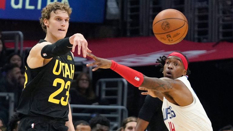 Utah Jazz forward Lauri Markkanen, left passes as Los Angeles Clippers guard Terance Mann defends