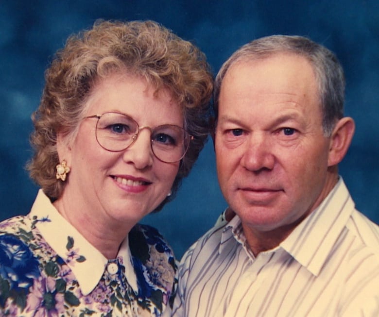 A woman, left, and a man smile into the camera.