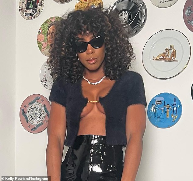 Closer look: The Atlanta-born 41-year-old showcased her ample assets in a black short-sleeved, scoop-neck fuzzy top held together by only a tiny gold clasp