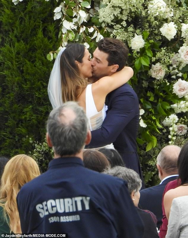 Proudly displaying their love to the world, the pair wrapped their arms around each other and enjoyed a passionate kiss after saying 'I do'