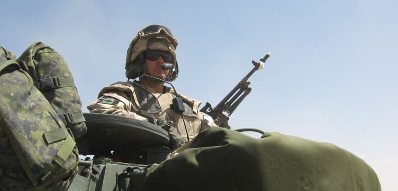 A man in uniform on a tank.