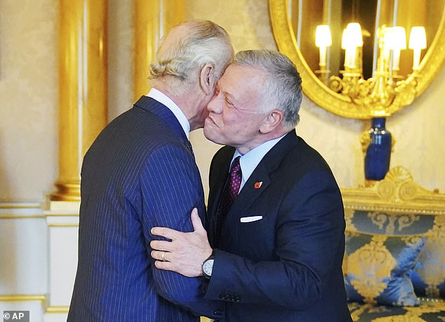 Charles is kissed by King Abdullah II of Jordan during an audience on Thursday