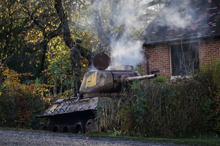 A UK instructor releases smoke inside a tank in preparation for a training exercise with the Ukraine recruits