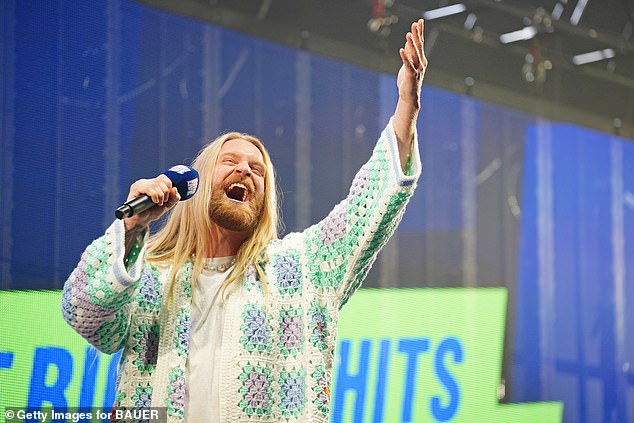 Performing: Sam Ryder opened his mouth up wide as he sang from the top of his lungs