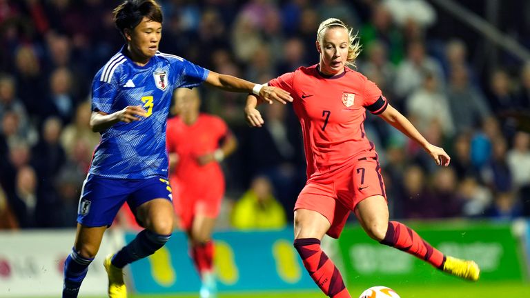 Japan&#39;s Moeka Minami challenges for the ball with England&#39;s Beth Mead