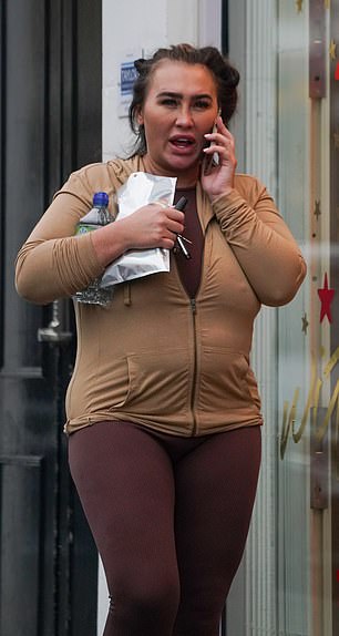 Looking good: The 35-year-old former TOWIE star showed off her curves in a pair of skin-tight brown leggings