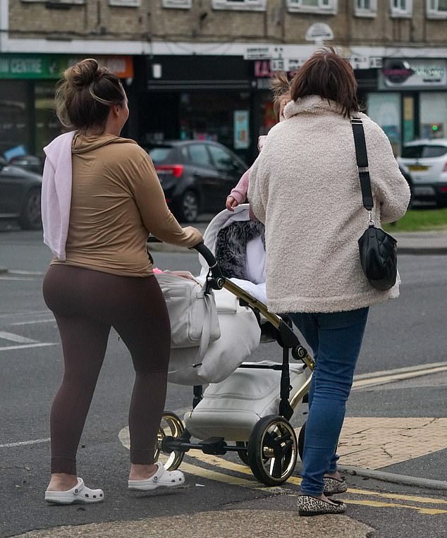 Day out: The reality star pushed along Larose's pram while she was carried by Lauren's mum Cheryl during the outing