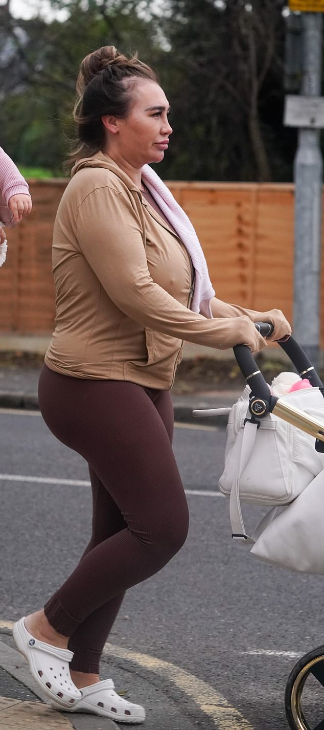 Casual: She donned a matching top which she wore underneath a beige zip-up hoodie while completing the look with a pair of white crocs