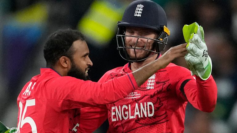 England&#39;s Adil Rashid, left, celebrates with captain Jos Buttler after the dismissal of Pakistan&#39;s captain Babar Azam during the final of the T20 World Cup cricket at the Melbourne Cricket Ground between England and Pakistan in Melbourne, Australia, Sunday, Nov. 13, 2022. (AP Photo/Mark Baker)