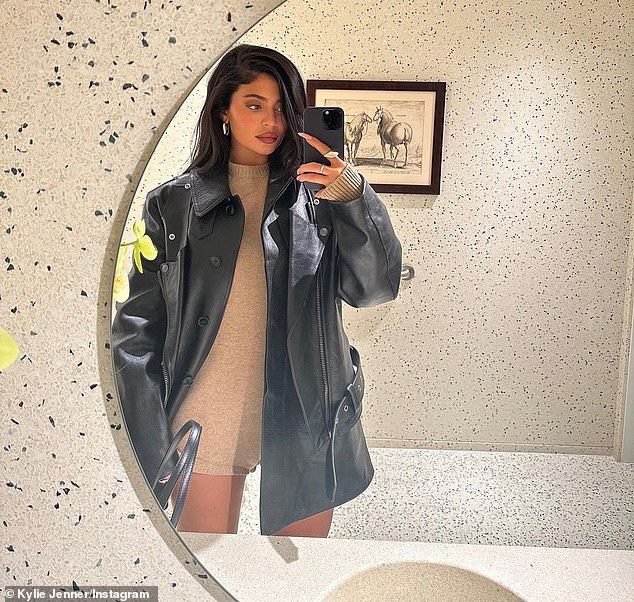 Edgy: The billionaire Kylie Cosmetics founder layered the cozy look with an oversized leather jacket that was also from Raf Simons