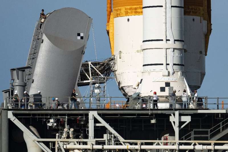 Engineers work on the Tail Service Mast Umbilical of the Artemis I unmanned lunar rocket as it sits on launch pad 39B at NASA's 