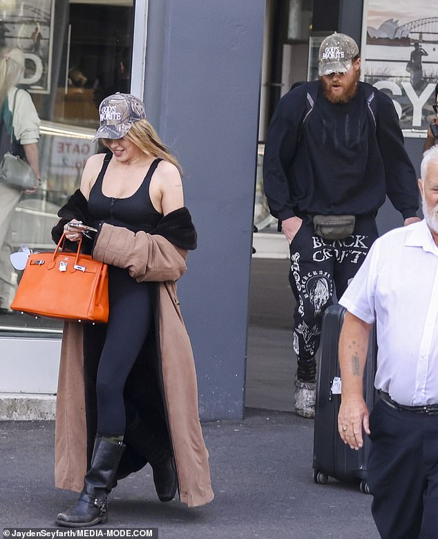 Imogen's husband dressed for comfort in sneakers, a jumper and a pair of Crocs