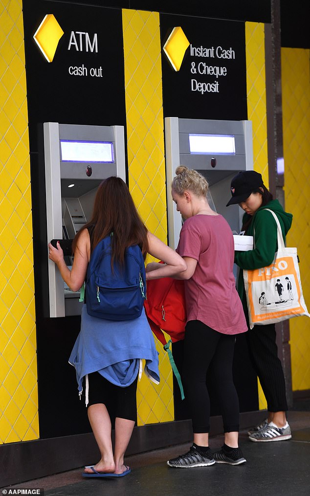 The RBA has been lifting interest rates aggressively since May despite implying they would remain unchanged until inflation was within its two to three per cent target, which wasn't expected until 2024 (pictured, customers use a Commonwealth Bank ATM)