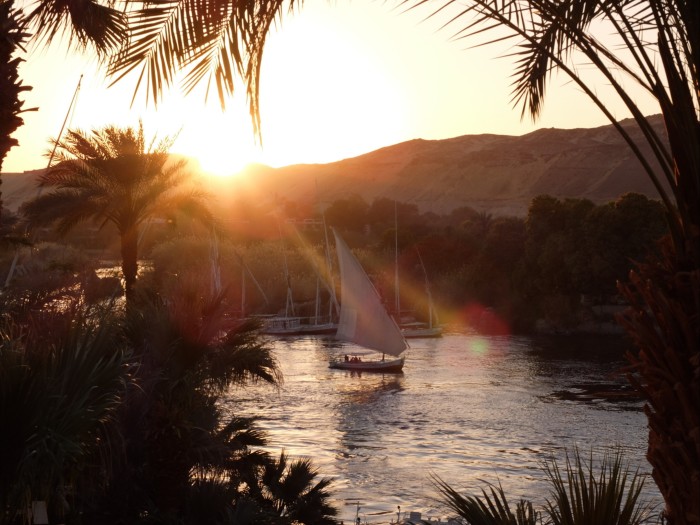 A sailing boat on the river as the sun sets