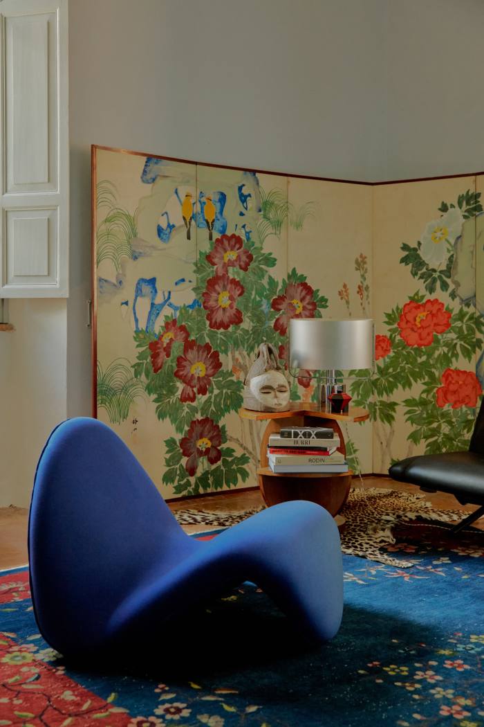 The tongue chair by Pierre Paulin, in front of a 1920s Japanese screen and art deco side table