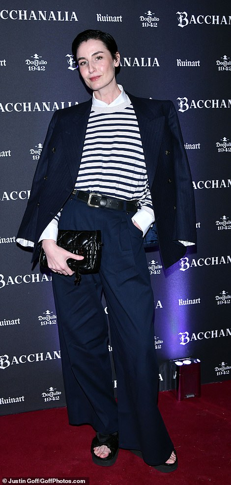 Smart: Erin O'Connor cut a suave figure in a striped jumper and white shirt