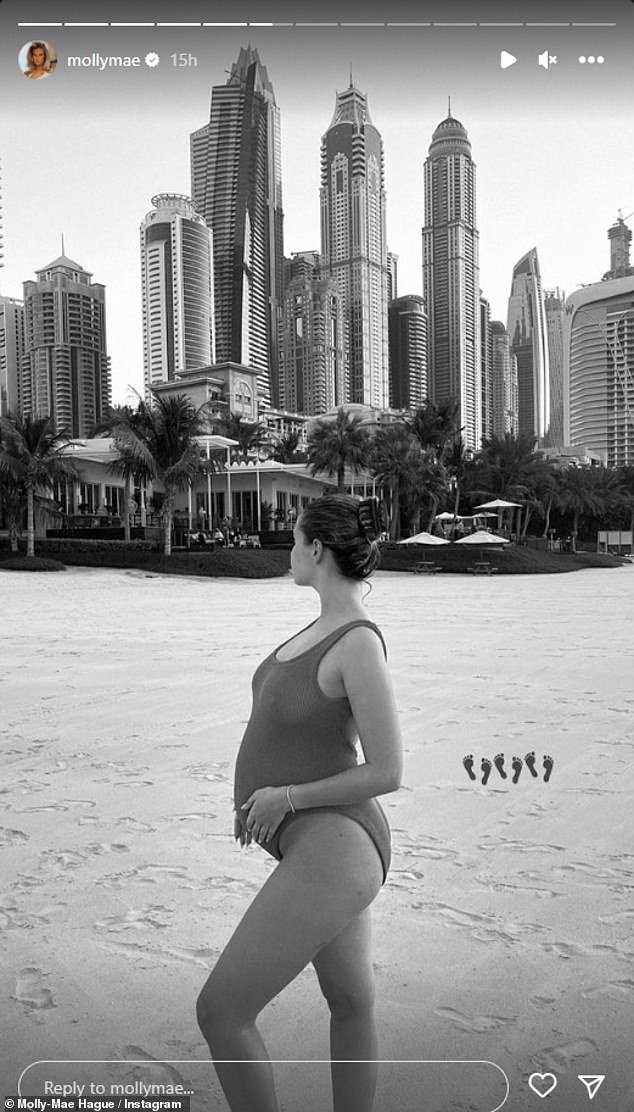 Mum-to-be: Amid her posts, the expectant mother also showcased a glimpse of her growing baby bump in her swimwear as she uploaded a stunning black and white snap in front of the Dubai skyline