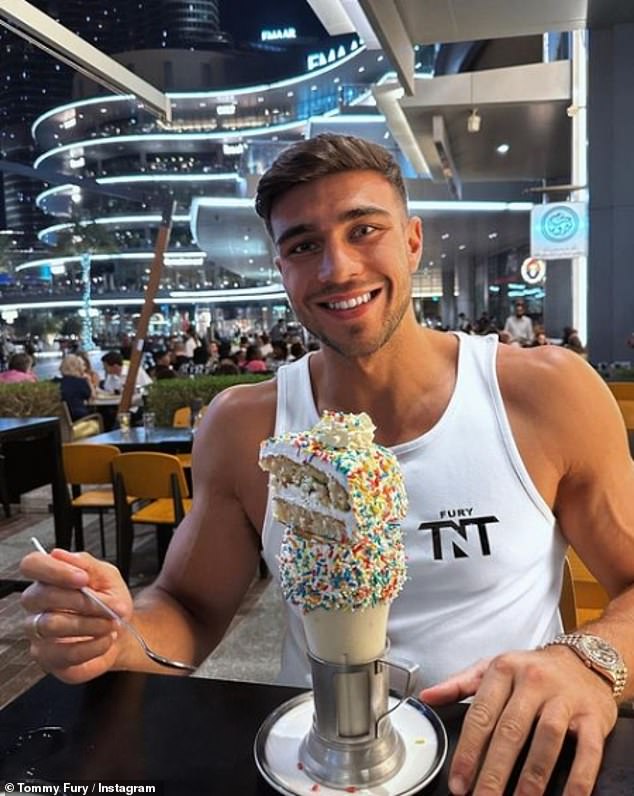 Cheat day: Tommy enjoyed himself following his match as he tucked into a huge milkshake toped with a slice of cake and sprinkles