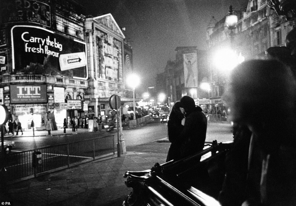 One of the regular power cuts takes out most of the lights in London's Piccadilly Circus in 1974