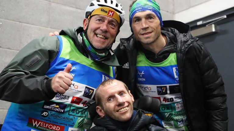 Sinfield was greeted by Rob Burrow (centre) after finishing his run at Headingley Stadium