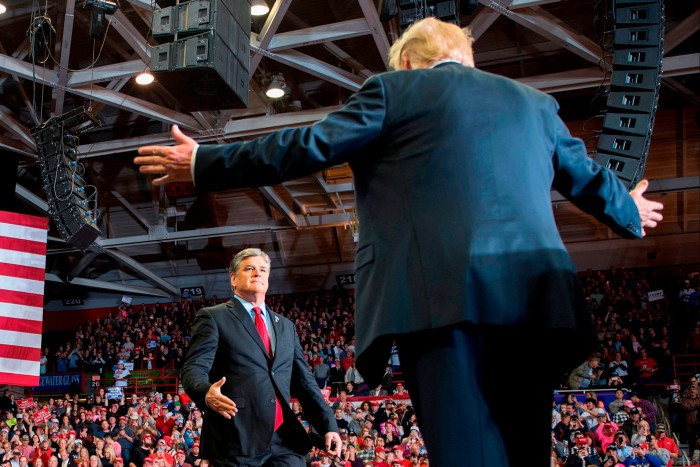 President Donald Trump greets Sean Hannity at a Make America Great Again rally in 2018