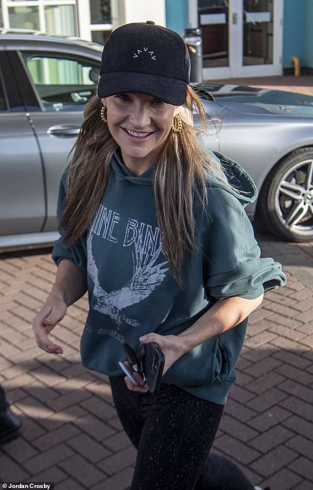 Low-key: Helen Skelton cut a casual figure in a teal hoodie, skin-tight leggings and a black baseball cap