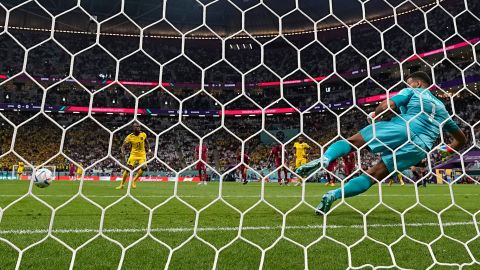 Valencia scores past Qatar's goalkeeper Saad Al Sheeb for Ecuador's opening goal. 