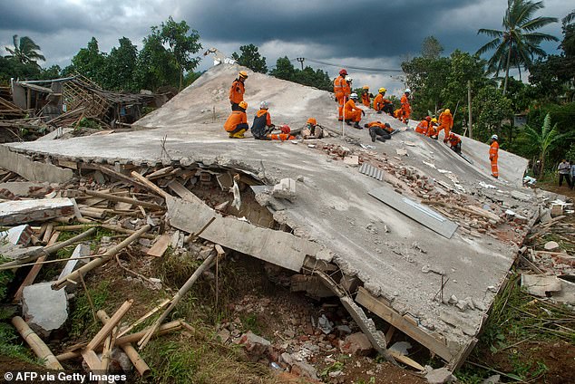 Rescue workers look for victims under the ruins of collapsed buildings in Cianjur on Tuesday