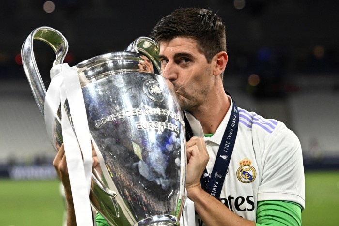 Thibaut Courtois celebrates with the trophy after winning the Champions League