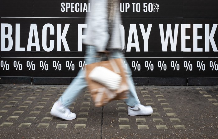 Shoppers walk through the retail district near Oxford Circus as the annual Black Friday sale event arrives,