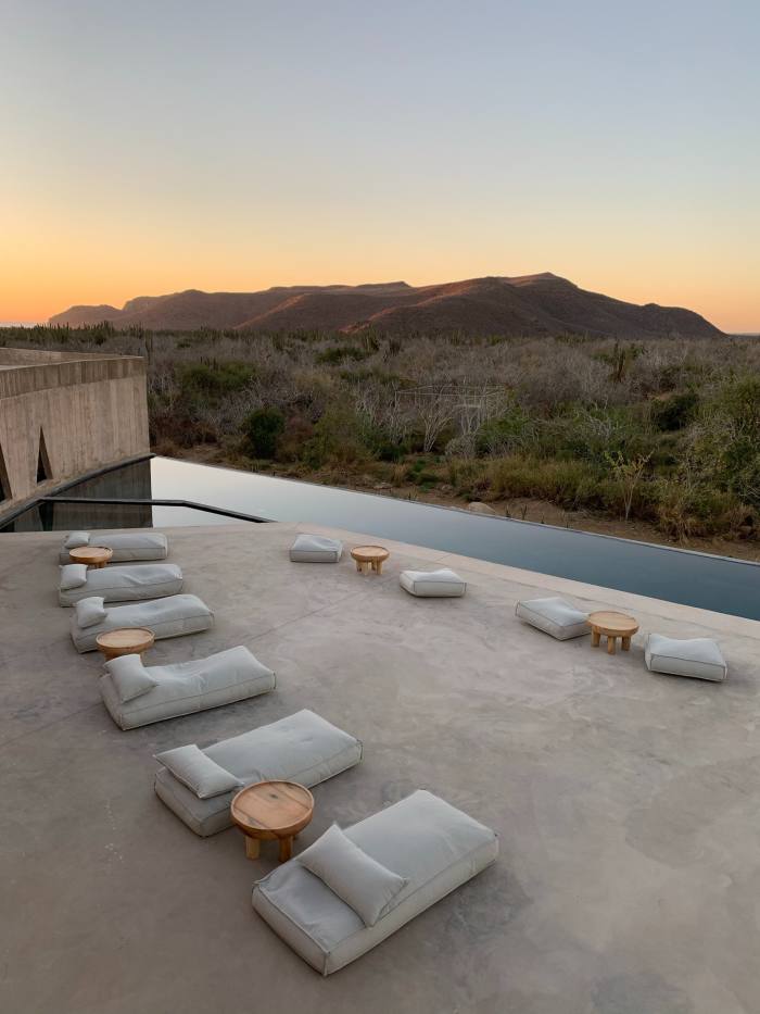 Outdoor seating overlooking desert and farmland at Paradero Todos Santos