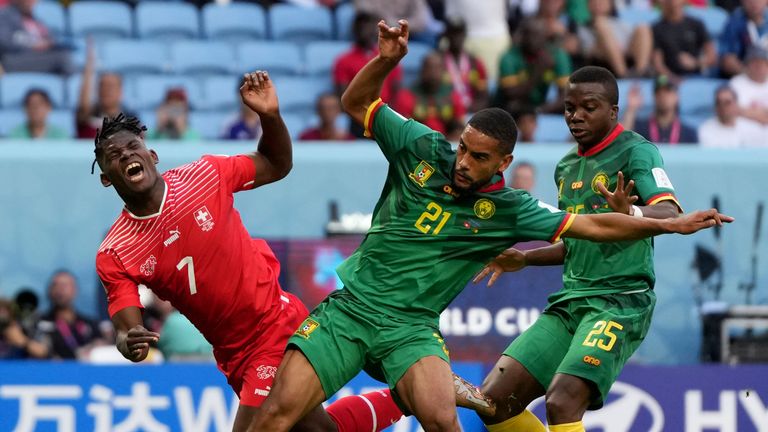 Switzerland&#39;s Breel Embolo (left) is challenged by Cameroon&#39;s Jean-Charles Castelletto (centre) and Tolo Nouhou during the World Cup Group G match