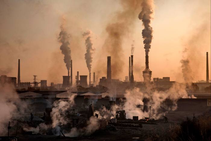 Smoke billows from a large steel plant