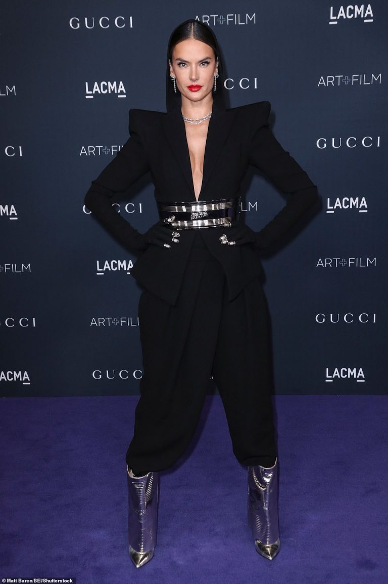 Alessandra Ambrosio adopts a powerful stance on the red carpet as she stuns in an all black suit