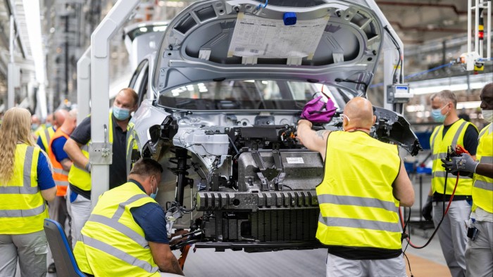 Employees work at the assembly line of the Volkswagen (VW) ID 4 electric car 