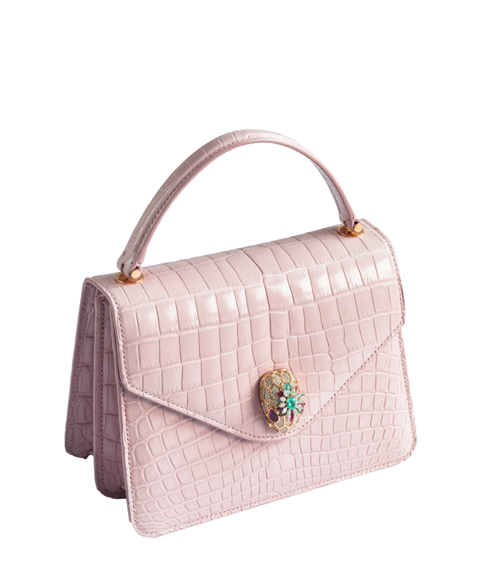 A pale pink handbag of crocodile leather with a bejewelled clasp