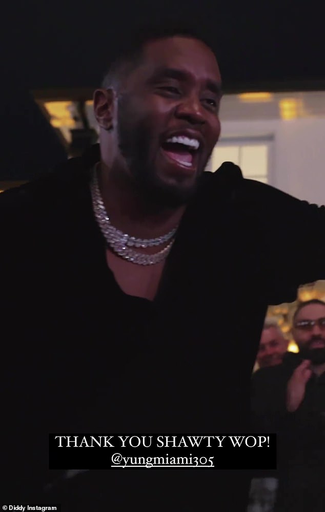 Diddy is gifted a flashy jewel-encrusted chain during his star-studded 53rd birthday party in LA