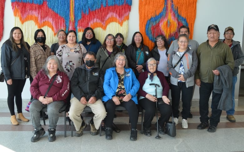 Seventeen people pose for a family photo at the inquest into the deaths of Don Mamakwa and Roland McKay.