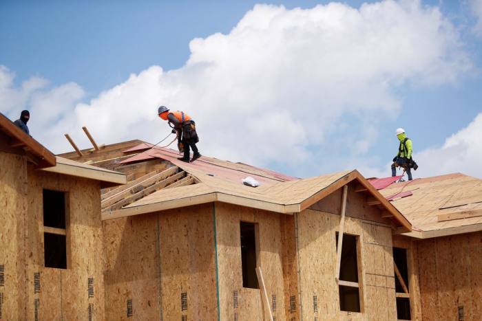 Carpenters work on new townhouses in Tampa, Florida