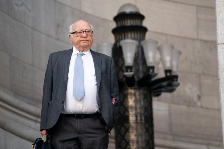 An older man with a briefcase.