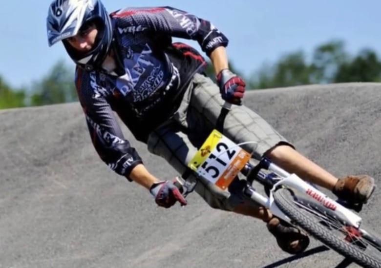 A cyclist on a downhill racing course. 