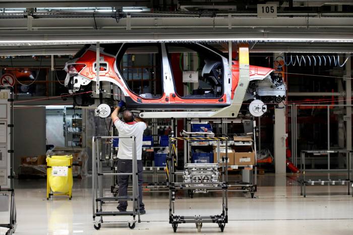 Workers assemble vehicles on the assembly line of the SEAT car factory in Martorell