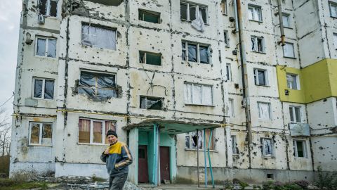 A local walks under a destroyed building in Vysokopillya, Kherson province, Ukraine. Nov. 11, 2022 