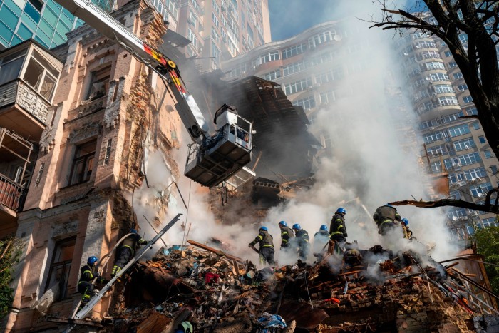 Firefighters work in rubble after a drone attack in Kyiv. The profits of energy companies have soared since Russia’s invasion of Ukraine 