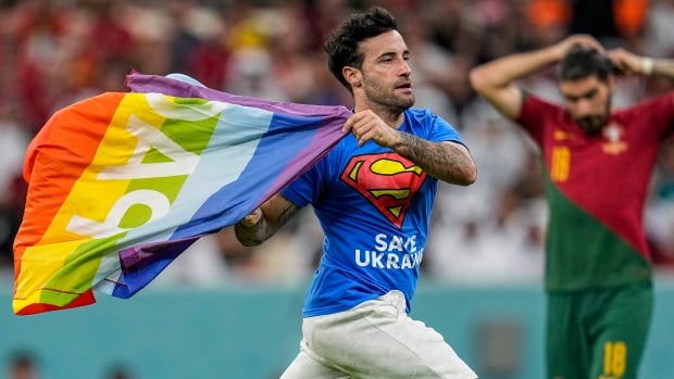 Protester with rainbow flag interrupts men’s World Cup game in Qatar