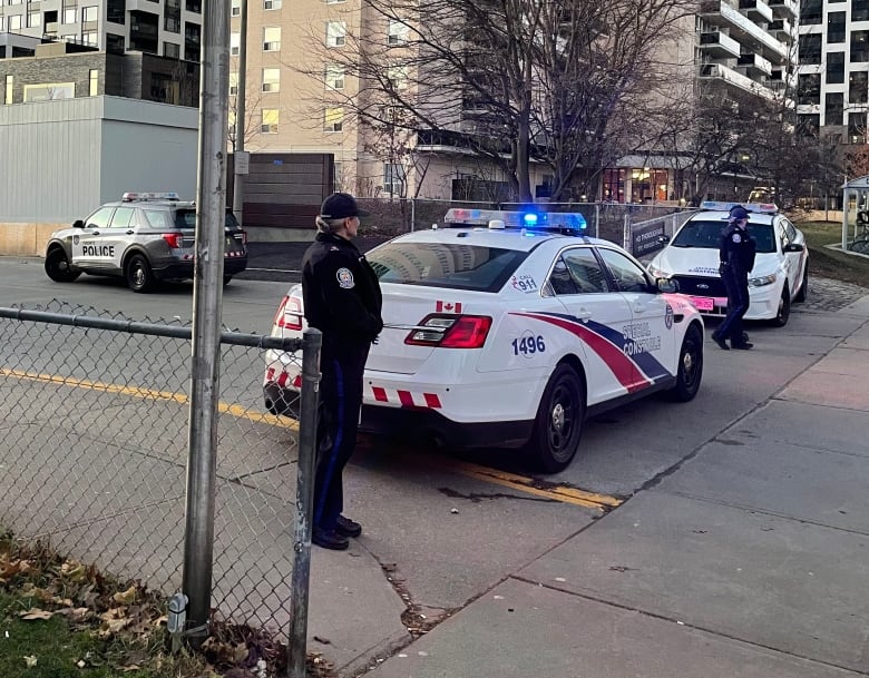 Two police cars block the entrance to the TTC station.