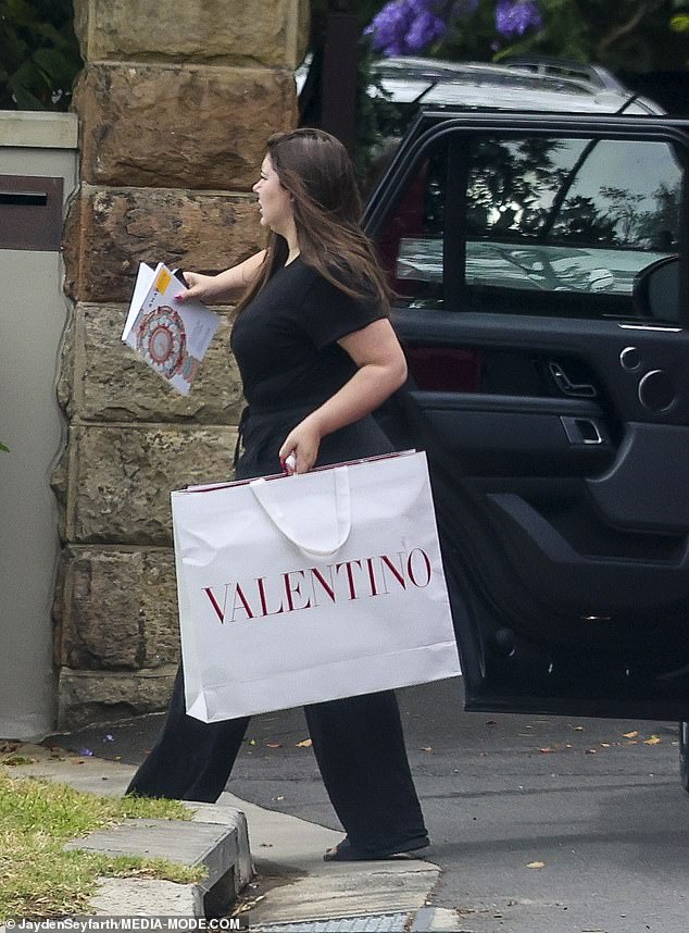 The 28-year-old donned a casual black ensemble with drawstring trousers and relaxed t-shirt