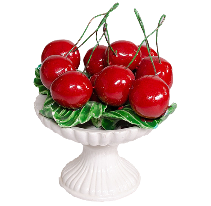 A china ornament of cherries in a white bowl